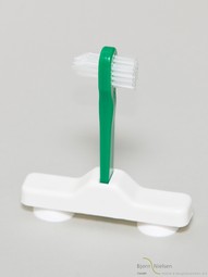 Denture brush with suction cup