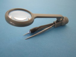 Tweezers with magnifying glass and light.