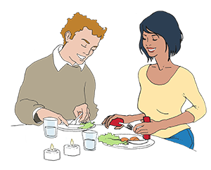 Couple eats using angled cutlery with thick grip 