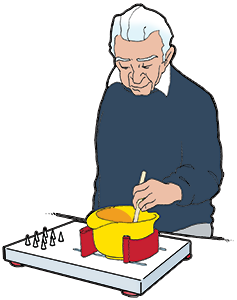 A man stirring a bowl, which is fixed to a cutting board with fixation facilities
